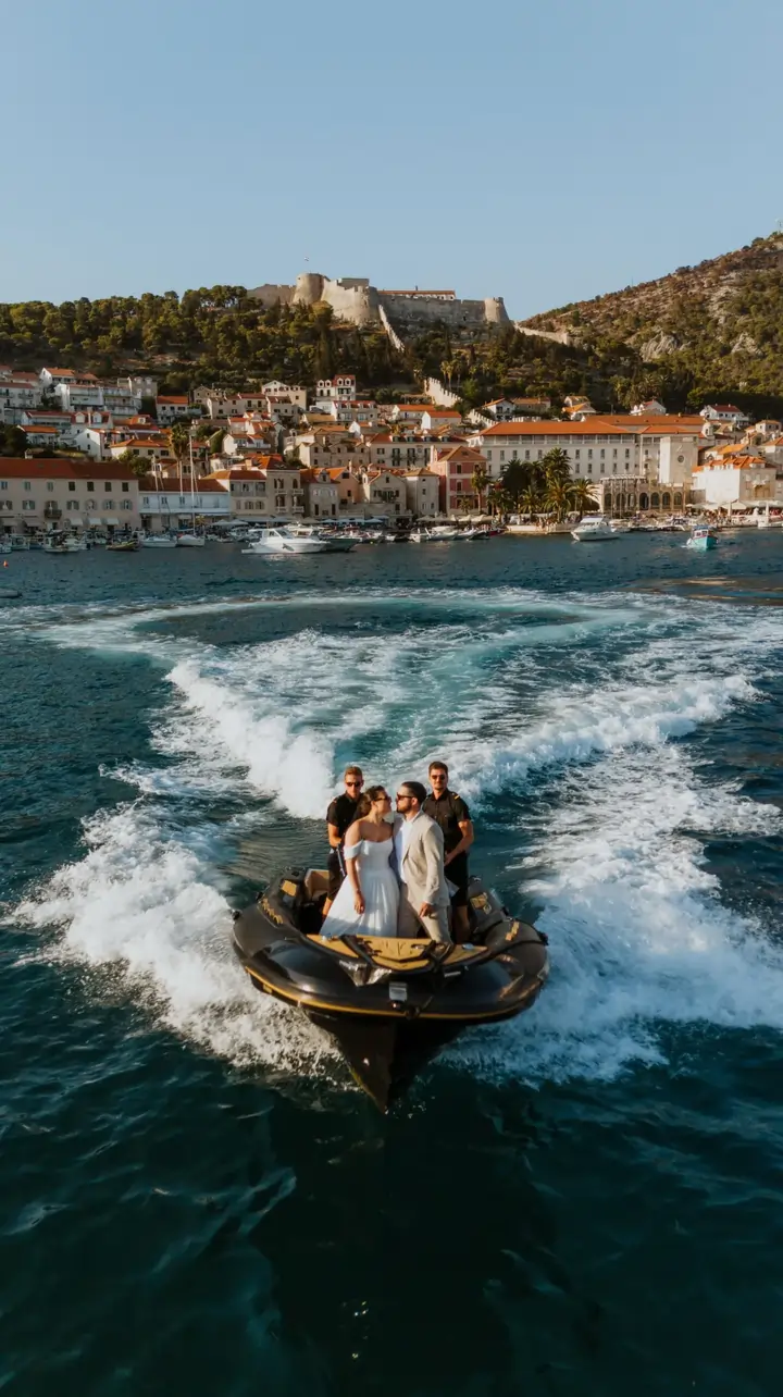 Couple on a boat trip in Croatia with waves and old city